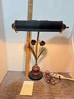 Full view of lamp showing shade, tulip accents, base, and ruler for scale