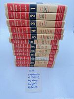 Stacked view of all twelve volumes showing numbered spines