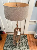 Full view of lamp with table and magazine rack