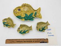 All four fish-shaped dishes with ruler for scale