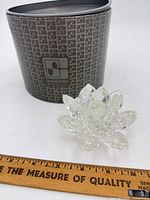 Candleholder beside presentation box with ruler for scale