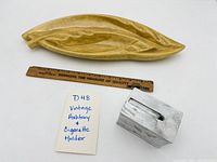 Leaf-shaped ceramic ashtray, ruler for scale, and cigarette holder
