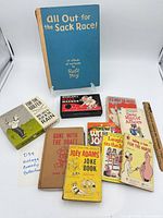 Group shot of all books and Bowler’s Ball Warmer