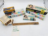 Group shot of all flashbulb boxes with ruler for scale