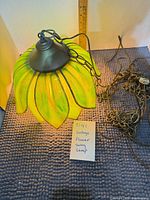 Full view of lamp showing petals, chain, cord, size reference