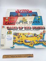 Stacked game boxes showing titles: Rand McNally Vacation and two Game of the States