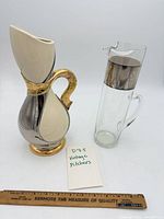 Both pitchers with ruler for scale