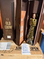 Boxed Old Crow Chessmen decanter visible on cardboard base