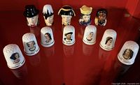 Front view of all 12 thimbles displaying character imagery