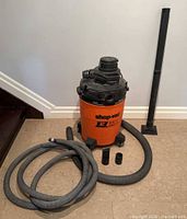 Full view of vacuum canister, rigid wand and hoses