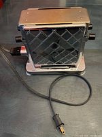 Front view showing diamond-patterned chrome side and attached power cord