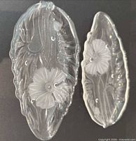 Top view both glass leaf dishes showing floral relief