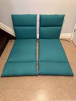 Both teal lounge chair cushions front view