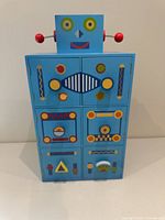 Front view of blue robot cabinet showing six decorative storage compartments and colorful detailing