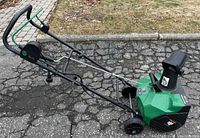 Left side view of Certified green and black electric snow blower showing handle, auger housing and wheels