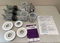 overview of three housings, three inserts, four trim rings, transformer, instructions