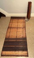 One blind unrolled, showing slat pattern and length