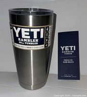 Front view of Yeti Rambler 20 oz tumbler with lid and booklet