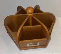 Angled view showing front compartments, knob, metal label holder