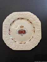 Front of commemorative plate showing design and embossed rim