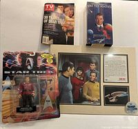 All four items arranged: action figure, VHS, TV Guide, collector’s print