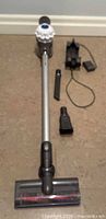 Full view of Dyson V6 vacuum with wand, cleaner head, wall mount, charger, crevice and combo tools