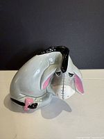 Front three-quarter view of Eeyore ceramic figurine showing colour and details