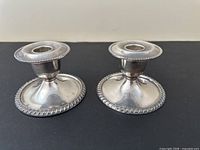 Front view of both Benedict Proctor silver-plated candlestick holders