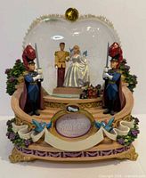 Front view showing Cinderella wedding snow globe with guards and photo frame