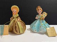 Both Josef Originals figurines side by side with hang tags visible