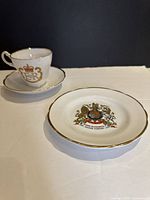 Teacup on saucer, plate beside; shows overall set and gilded rims