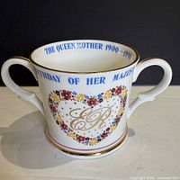 Front view showing floral heart design with ER monogram and twin handles