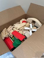 Cardboard box filled with wooden railway components