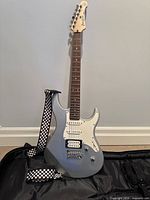 Front view of Yamaha PAC012 guitar with strap on gig bag