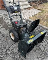 Front three-quarter view showing full blower, auger housing, wheels, controls