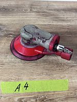 Top view of 3M pneumatic orbital sander showing overall shape and pad