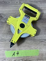 Full view of Benchmark yellow open-reel tape showing housing and tape