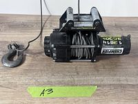 Full view of Champion winch with cable and hook