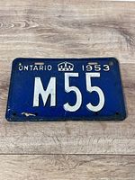 Front view of blue 1953 Ontario licence plate M55