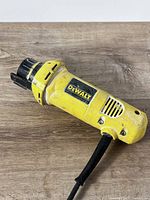 Left side view of DeWalt DW660 showing label, collet assembly and cord
