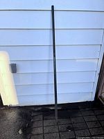 Full length view of steel bar leaning against wall