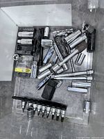 Bin showing assorted sockets, extensions, bit rail