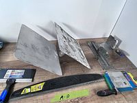 Group of drywall tools including hawks, taping knife, darby/float, trowels
