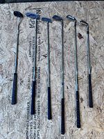 Six golf clubs on OSB board