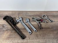 All five tools laid out on wood surface