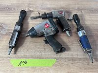 Group shot of all four pneumatic tools on wooden surface
