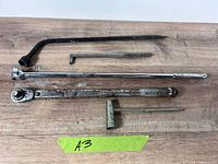 Group shot of all five automotive hand tools laid on wood surface