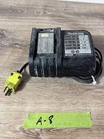 Full view of Makita DC18SD charger with cord and yellow plug