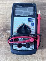 Front view of Mastercraft digital multimeter with test leads wrapped around unit