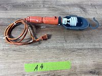 Full view of trouble light with cord and cage